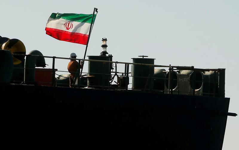 REFILE - CORRECTING GRAMMAR  A crew member raises the Iranian flag on Iranian oil tanker Adrian Darya 1, previously named Grace 1, as it sits anchored after the Supreme Court of the British territory lifted its detention order, in the Strait of Gibraltar, Spain, August 18, 2019. REUTERS/Jon Nazca