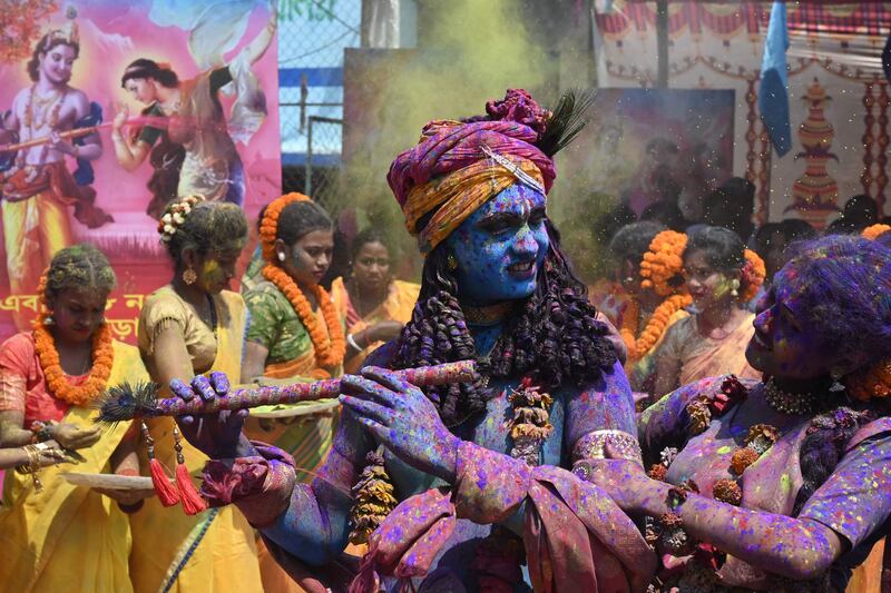 A youth dressed as Lord Krishna takes part in Holi celebrations in Kolkata, India. AFP