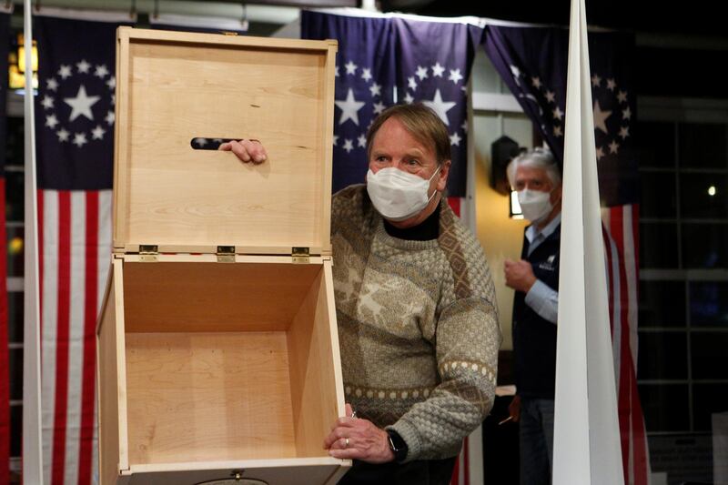 A poll worker shows an empty box for ballots for the U.S. presidential election at the Hale House at Balsams Hotel in the hamlet of Dixville Notch, New Hampshire. Reuters