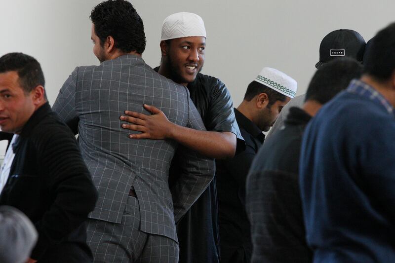 CHRISTCHURCH, NEW ZEALAND - AUGUST 23:  Members of the Linwood Islamic Centre congregation and visiting muslims embrace each other as Friday Prayer concludes on August 23, 2019 in Christchurch, New Zealand. The Christchurch Islamic community  continue to receive international visitors and letters of support. 51 people were killed and dozens were injured following the worst mass shooting in New Zealandâ€™s history after a man opened fire at Al Noor Mosque and the Linwood Islamic Centre in Christchurch on 15 March 2019. The Australian gunman is now facing 51 charges of murder and 40 of attempted murder as well as engaging in a Terrorist Act and is due to go on trial in May 2020. (Photo by Lisa Maree Williams/Getty Images)