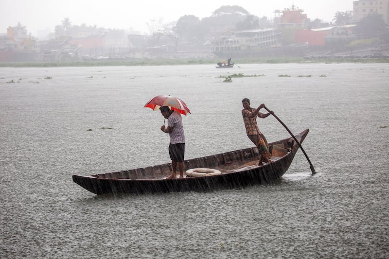 Crossing the Buriganga river during heavy rain caused by cyclone Asani in Dhaka, Bangladesh. EPA