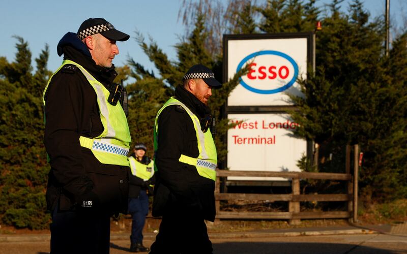 Police officers guard the entrance at Esso West London Terminal during the Extinction Rebellion demonstration. Reuters