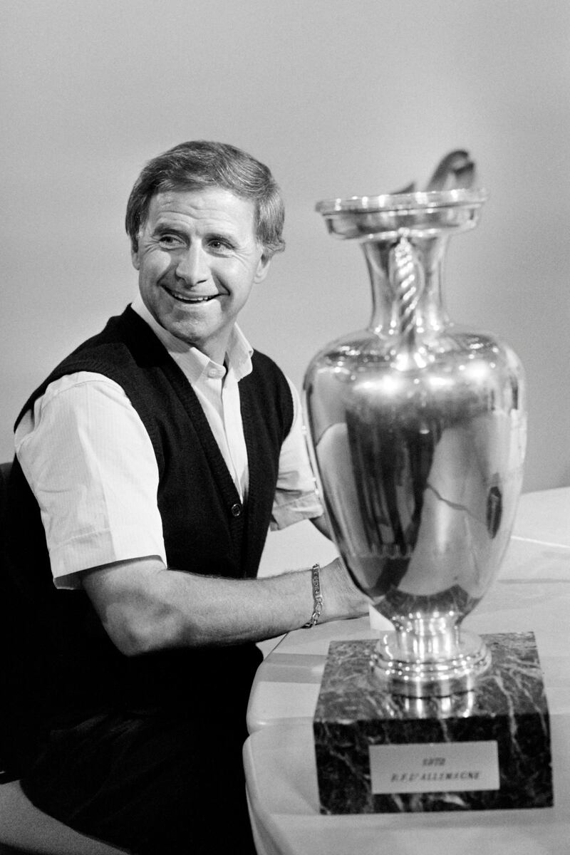 Portrait taken on June 28, 1984 on Le Journal de 20h (The 20h Journal) program on TF1 television shows coach of French national team Michel Hidalgo with the trophy of the European Nations championship on the next day of the victory against Spain at the Parc des princes stadium in Paris. (Photo by Joel ROBINE / AFP)