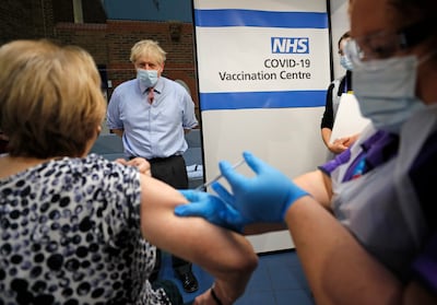 Boris Johnson watches as a nurse administers the Pfizer-BioNTech vaccine at Guy's Hospital in London. Getty Images
