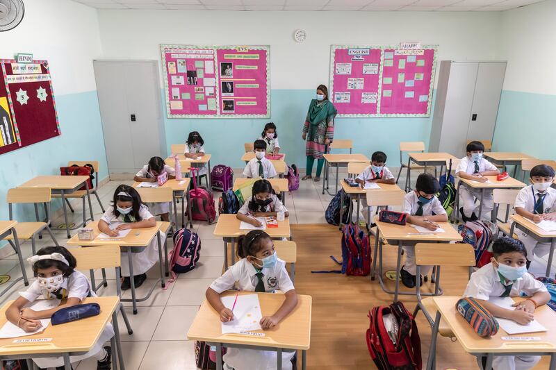 Masked pupils learn in a classroom at the Delhi Private School.