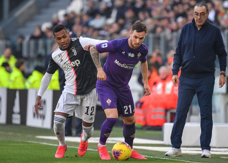 Fiorentina's defender Pol Lirola, centre, vies with Juventus defender Alex Sandro. AFP