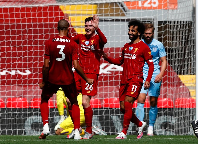 Liverpool's Andrew Robertson, second left, celebrates with teammates after scoring the opening goal against Burnley at Anfield on Saturday. AP