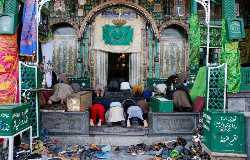 Men offer prayers outside a shrine in Srinagar, the summer capital of Indian Kashmir.  EPA