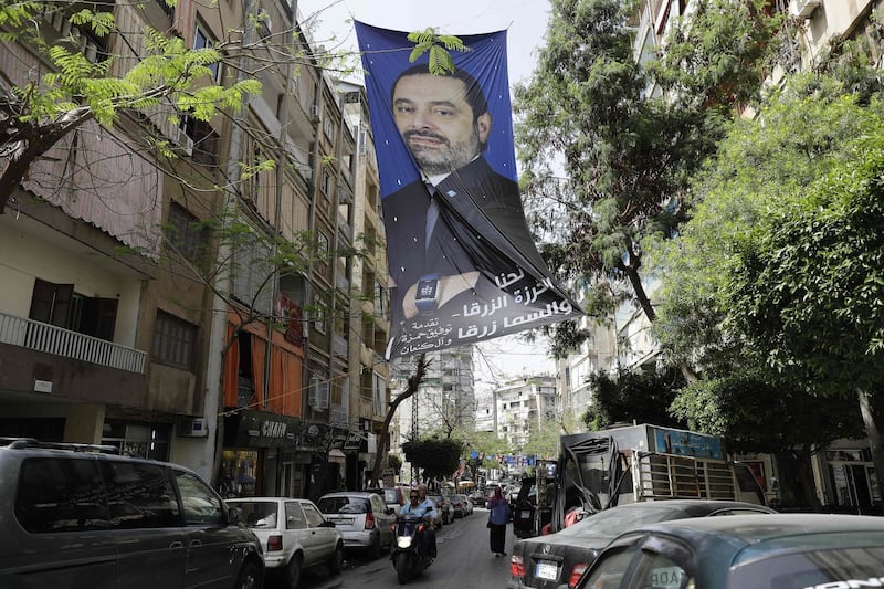 A portrait Lebanese Prime Minister Saad Hariri hangs above a crowded street in central Beirut on May 4, 2018, ahead of the weekend's legislative elections.
Lebanon elects its parliament for the first time in nine years on Sunday, with its ruling parties seeking to preserve a fragile power-sharing arrangement despite regional tensions. / AFP PHOTO / JOSEPH EID