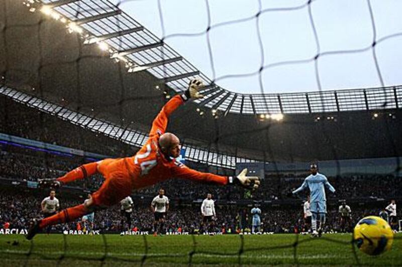 Brad Friedel of Tottenham Hotspur is unable to stop Mario Balotelli's late penalty.