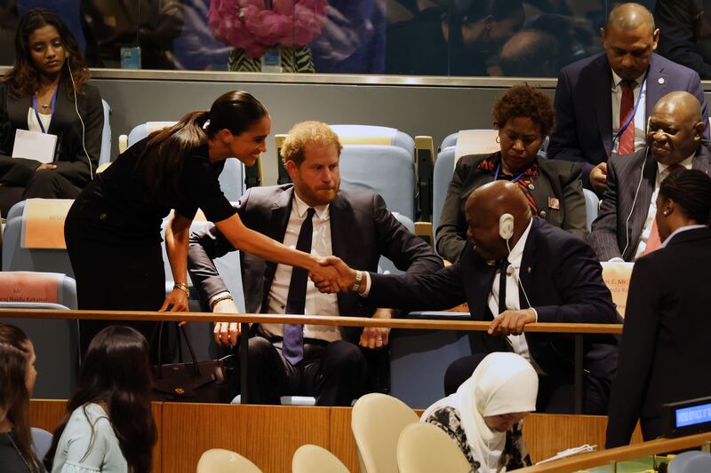 Prince Harry and his wife Meghan greet Guinea’s Foreign Minister Morissanda Kouate. AFP