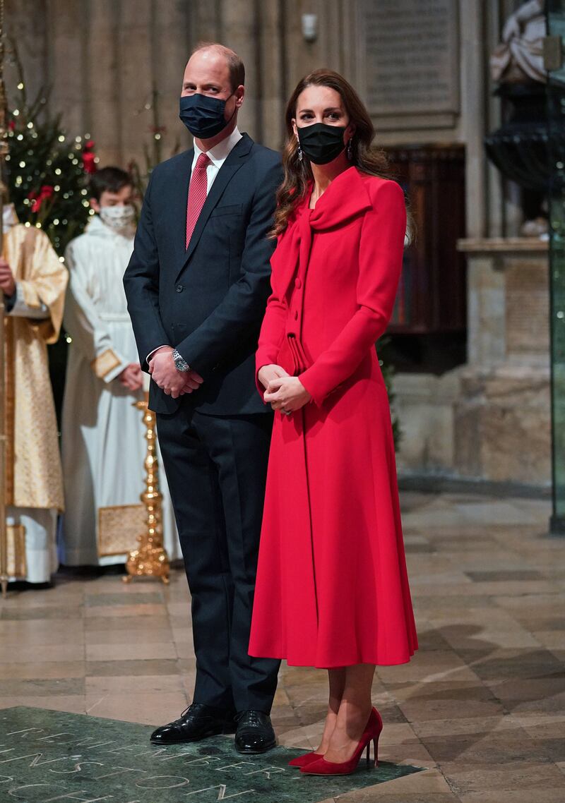 Prince William, Duke of Cambridge, and Catherine, Duchess of Cambridge, who wears a red Catherine Walker coatdress, at Westminster Abbey for the 'Royal Carols – Together At Christmas' carol concert on December 8, 2021. Getty Images