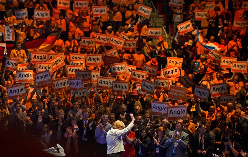 Mrs Merkel waves at an election campaign rally for federal elections in Dusseldorf, in 2013. Getty Images