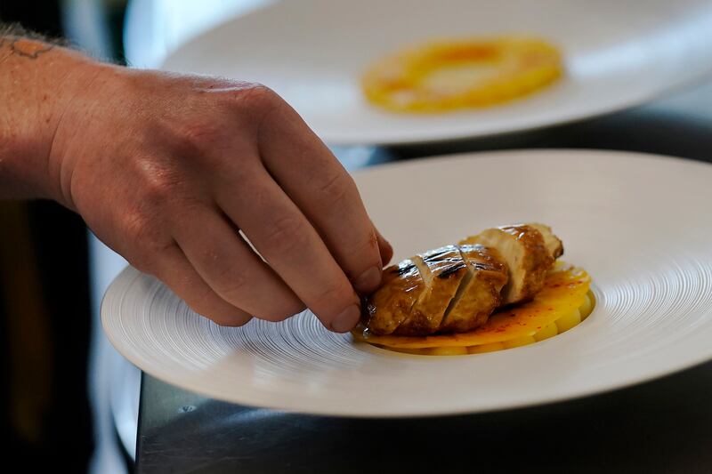 Chef Zach Tyndall prepares Good Meat's chicken cultivated from animal cells in California. AP Photo