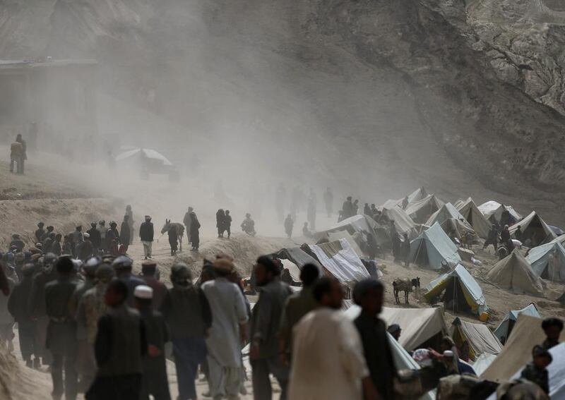 Afghan displaced villagers gather near the site of a landslide at the Argo district in Badakhshan province. Mohammad Ismail / Reuters