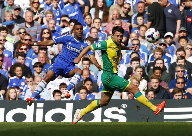 Chelsea's Ashley Cole, left, challenges Norwich City's Russell Martin during their English Premier League match at Stamford Bridge in London on May 4, 2014. Eddie Keogh / Reuters