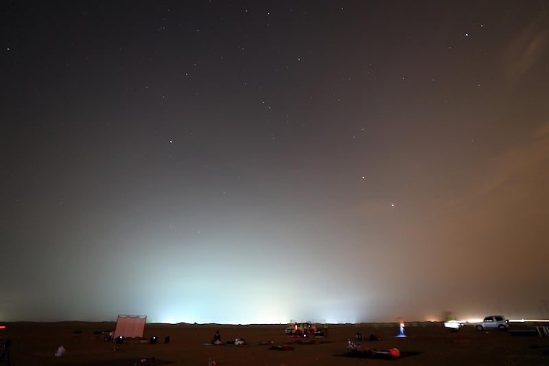 DUBAI, UNITED ARAB EMIRATES , August 13 – 2020 :- People watching the Perseid meteor shower at the Al Qudra desert area in Dubai. The event was organized by Dubai Astronomy Group with all the precaution against Covid 19 such as safe distance between the families and mask was mandatory. The event started on August 12 at 10pm to 2am on August 13.  (Pawan Singh / The National) For News/Standalone/Online/Instagram/Big Picture