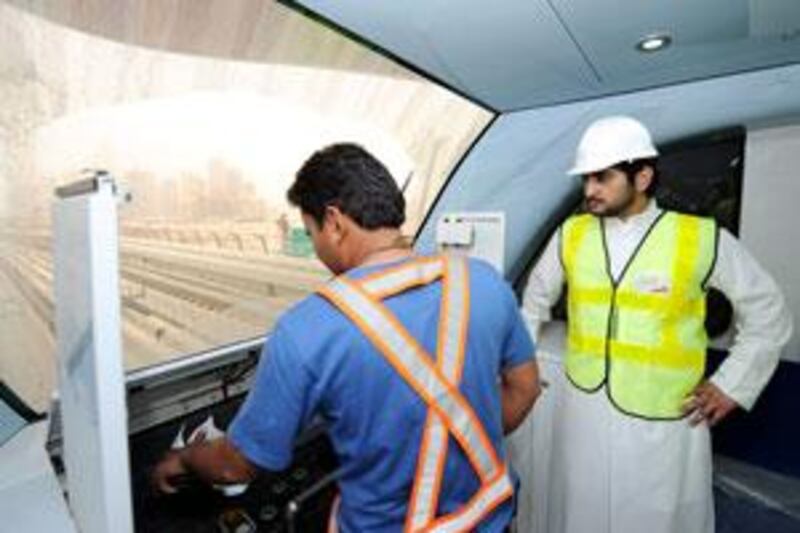 Sheikh Maktoum bin Mohammed, Deputy Ruler of Dubai, watches a Metro driver at work during inspection of the system.