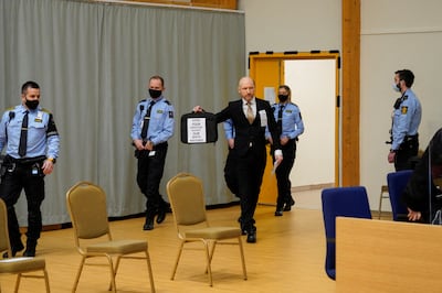 Mass killer Anders Breivik arrives at the makeshift courtroom in Skien prison, Norway, carrying a bag bearing a white supremacist message. Reuters