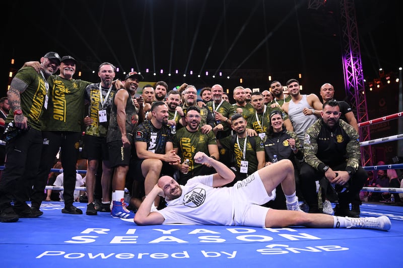 Fury poses for a photo with his team and Joseph Parker following a public workout. Getty Images