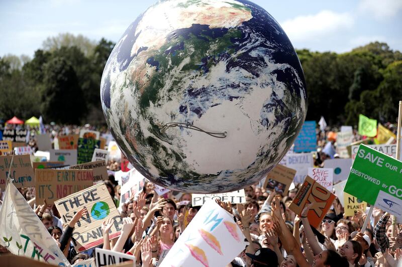 A large inflatable globe is bounced through the crowd in Sydney. AP Photo