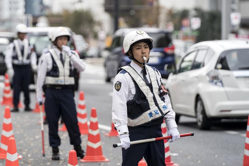 Police officers stand at a check point to inspect vehicles as Japan prepares for the enthronement of Emperor Naruhito.   Getty