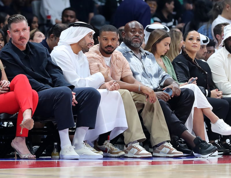 Actor Michael B Jordan with Mohamed Khalifa Al Mubarak, centre left, during the game. Chris Whiteoak / The National