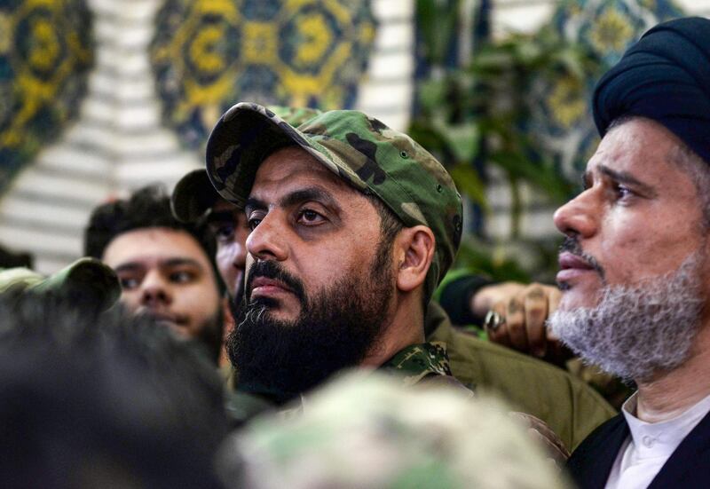 Qais al-Khazali (C) commander of the Asaib Ahl al-Haq pro-Iran faction attends the funeral procession of slain Iraqi paramilitary chief Abu Mahdi al-Muhandis, Iranian military commander Qasem Soleimani and eight others at the Imam Ali Shrine in the shrine city of Najaf in central Iraq on January 4, 2020. Thousands of Iraqis chanted "Death to America" today as they mourned the deaths of  al-Muhandis and Soleimani, who were killed in a US drone attack that sparked fears of a regional proxy war between Washington and Tehran. / AFP / Haidar HAMDANI

