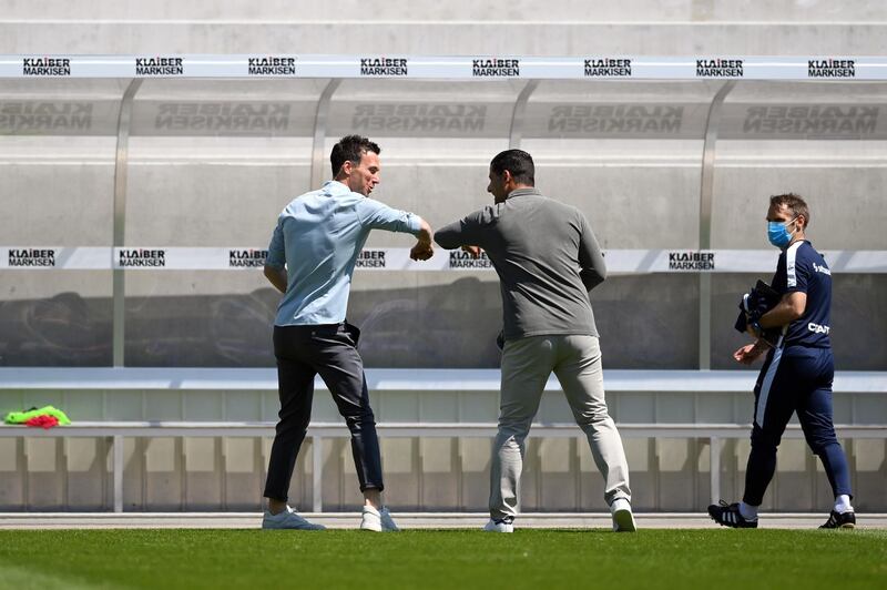 Head coaches Christian Eichner (L) of Karlsruhe and Dimitrios Grammozis of Darmstadt do an elbow bump prior to the Second Bundesliga match between Karlsruher SC and SV Darmstadt 98 at Wildparkstadion in Karlsruhe, Germany.he end of the season will be played behind closed doors. Getty