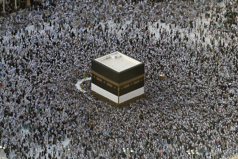 (FILES) In this file photo taken on August 8, 2019, Muslim pilgrims gather around the Kaaba, Islam's holiest shrine, at the Grand Mosque in Saudi Arabia's holy city of Mecca, prior to the start of the annual Hajj pilgrimage in the holy city. Saudi Arabia announced today it will allow 60,000 residents of the kingdom, vaccinated against the coronavirus, to perform the annual hajj, state media reported. / AFP / FETHI BELAID
