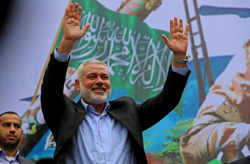 FILE - In this Dec. 12, 2014 file photo, Palestinian top Hamas leader Ismail Haniyeh greets supporters during a rally to commemorate the 27th anniversary of the Hamas militant group, in the northern Gaza Strip. A public opinion poll shows that Palestinian President Mahmoud Abbas would lose to the leader of the Islamic militant group Hamas if elections were held today. The poll conducted by prominent pollster Khalil Shikaki and released Tuesday, Dec. 18, 2018 shows that Hamas leader Ismail Haniyeh would win with 49 percent to Abbas' 42 percent. (AP Photo/Adel Hana, File)