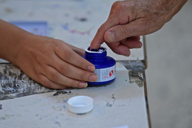 In a polling station in the Ariana district of Tunis, a citizen dips his finger in ink after taking part in a referendum on a draft constitution. AFP