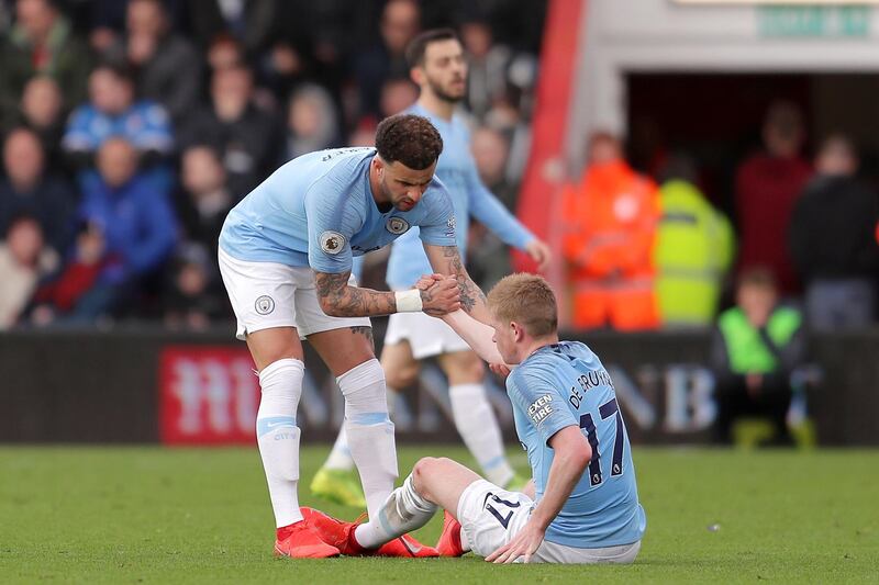 Kyle Walker of Manchester City helps De Bruyne after going down injured. Getty Images