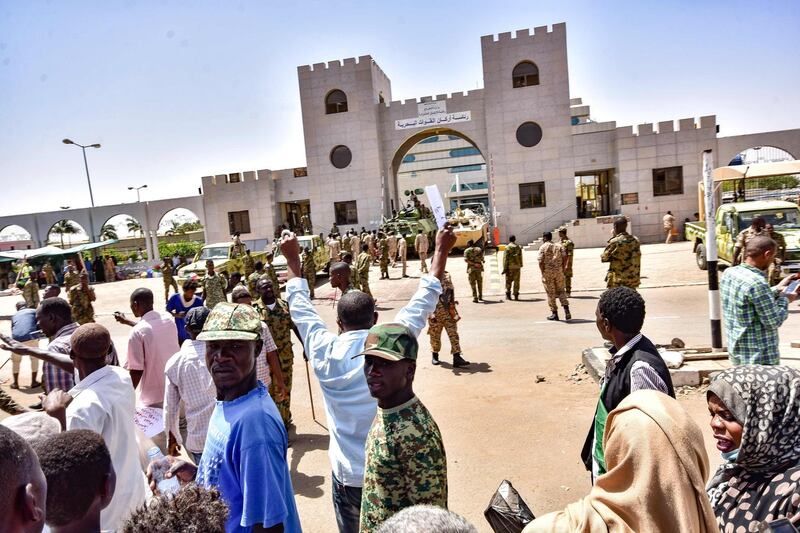 Sudanese demonstrators gather during a rally demanding a civilian body to lead the transition to democracy, outside the army headquarters in the Sudanese capital Khartoum.  Sudan's new military leader General Awad Ibn Ouf resigned late on April 12 just a day after being sworn in, as the country's army rulers insisted they would pave the way for a civilian government.  AFP