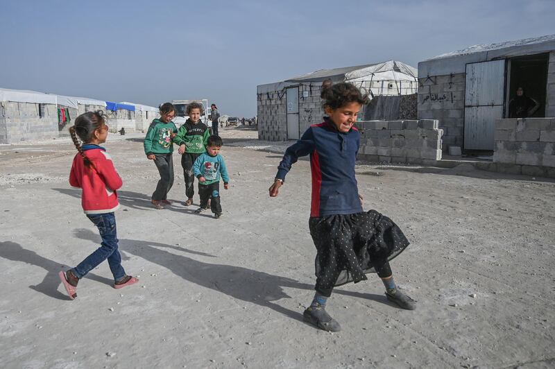 Displaced Syrian children play in a camp created by Turkey's Humanitarian Relief Foundation (IHH) in Kafr Lusin village on the border with Turkey in Syria's northwestern province of Idlib. When protesters in March 2011 demanded their rights and regime change, they likely never imagined it would trigger a reaction that has led to the 21st century's biggest war. Nine years on, President Bashar al-Assad is still in power and there to stay, more than 380,000 people have died, dozens of towns and cities razed to the ground and half of the country's entire population displaced.  AFP