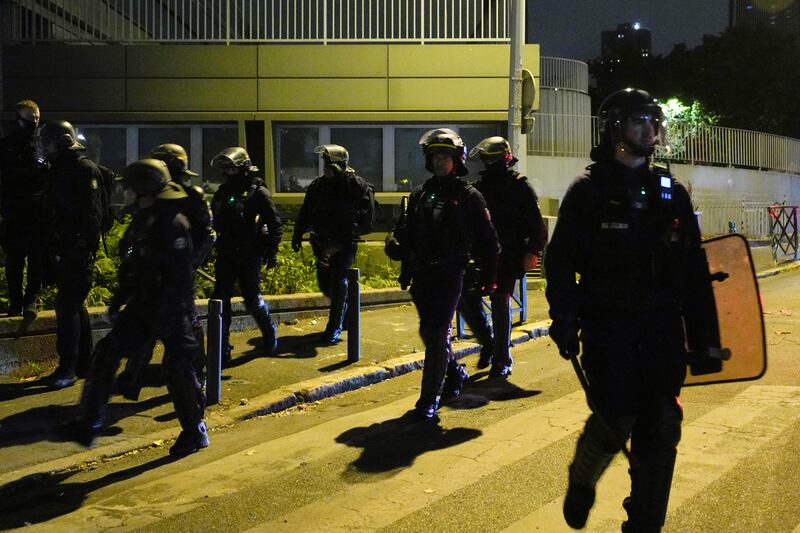 Police officers patrol in Nanterre, outside Paris.  AP