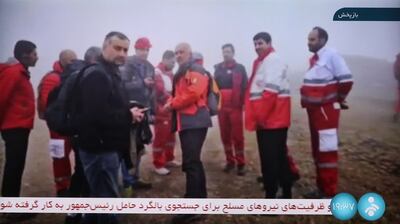 A screengrab from Iranian state television shows rescuers heading towards the site of the crash. AFP