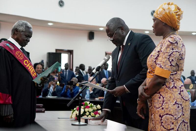 South Sudan's First Vice President Riek Machar stands with his wife Angelina Teny as he takes the oath of office in front of Chief of Justice Chan Reech Madut, at the State House in Juba, South Sudan. Reuters