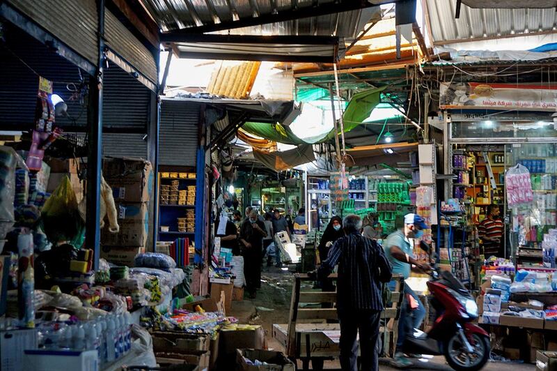 People shop at a market in Baghdad's Sadriya neighbourhood.  AFP