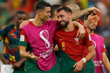 Portugal's forward #07 Cristiano Ronaldo (L) and Portugal's midfielder #08 Bruno Fernandes celebrate after they won the Qatar 2022 World Cup Group H football match between Portugal and Uruguay at the Lusail Stadium in Lusail, north of Doha on November 28, 2022.  (Photo by Odd ANDERSEN  /  AFP)