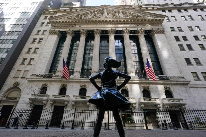 The Fearless Girl statue stands in front of the New York Stock Exchange in New York's Financial District, Tuesday, March 23, 2021.  Stocks are off to a solid start on Wall Street as banks made up some of the ground they lost a day earlier. Industrial companies were also strong early Wednesday, March 24 helping to push the benchmark S&P 500 index up 0.5% in the first few minutes of trading. (AP Photo/Mary Altaffer)