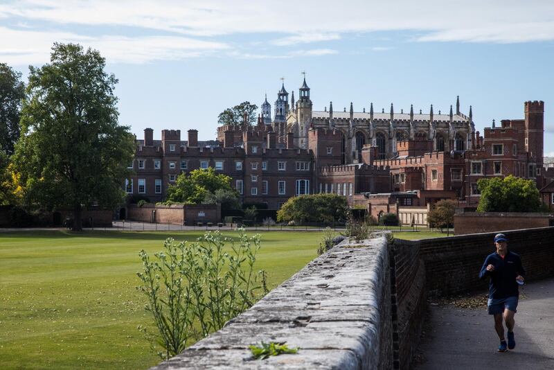 A man runs past Eton College and Eton College Chapel on 26 September 2020 in Eton, United Kingdom. There was an outbreak of the coronavirus at Eton College in early September after several students tested positive for Covid-19 upon their return to the school following the summer holidays. (photo by Mark Kerrison/In Pictures via Getty Images)