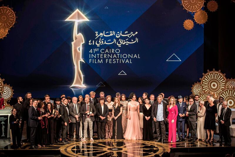 Members of the jury of the 41st edition of the Cairo International Film Festival pose for a group photo with award winners at the conclusion of the festival's closing ceremony at the Cairo Opera House. AFP