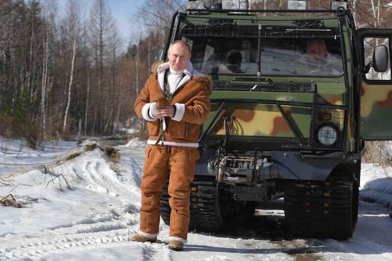 Russian President Vladimir Putin is pictured in front of an all-terrain vehicle while on holiday in Siberia. EPA