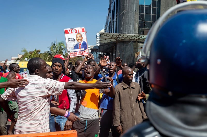 MDC Alliance supporters protest the vote count outside the ZEC Offices in Harare, Zimbabwe. EPA