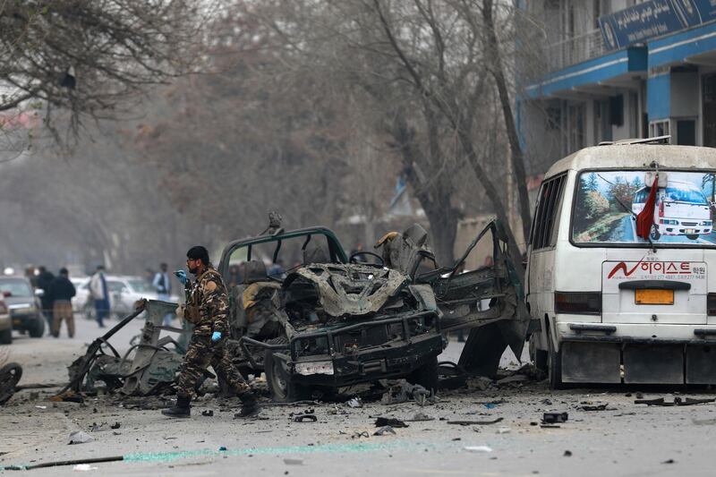 Afghan security personnel inspect the site of a bomb attack in Kabul, Afghanistan, Saturday, Dec. 26, 2020. A series of explosions hit the Afghan capital on Saturday morning. (AP Photo/Rahmat Gul)