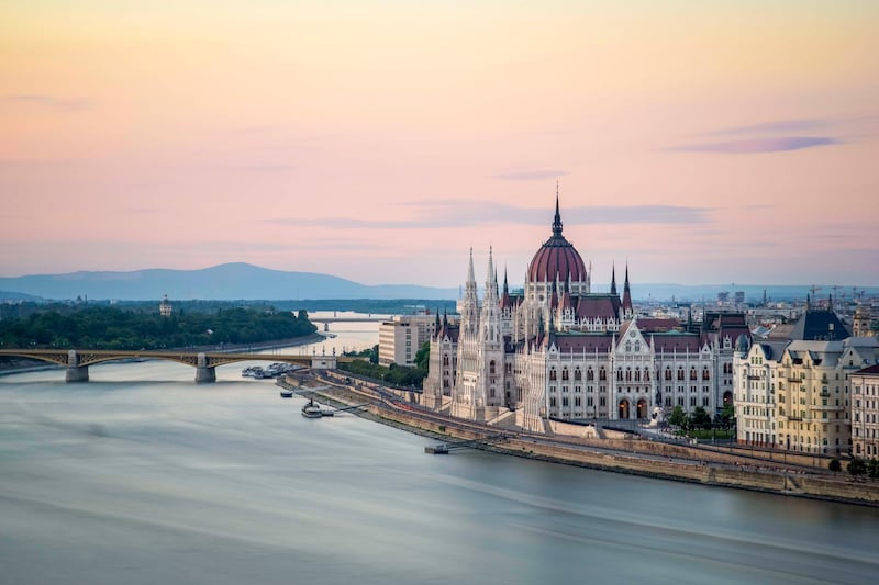 The Hungarian Parliament Building on the Banks of the Danube at dawn. Getty Images