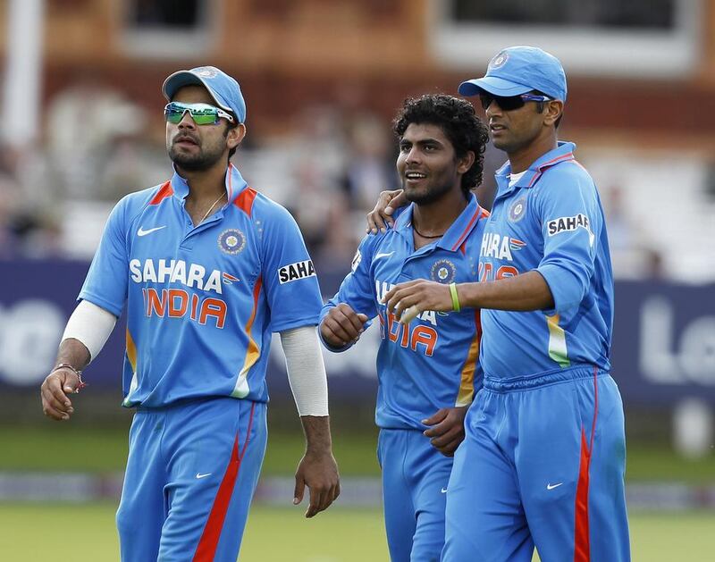 Virat Kohli, left, Ravindra Jadeja, centre, and Rahul Dravid are among a very select few to have graduated from the India U19s to the senior side. Ian Kington / AFP