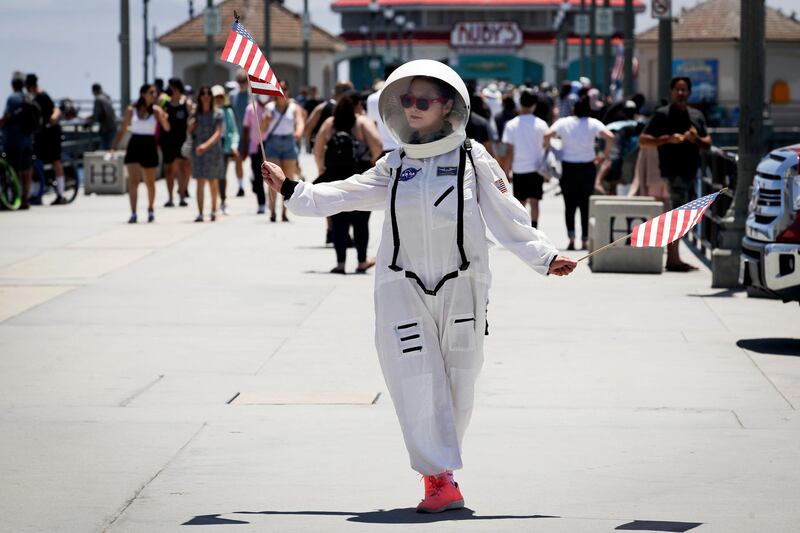 A visitor wears a space suit costume on the pier in Huntington Beach, California, US. AP Photo