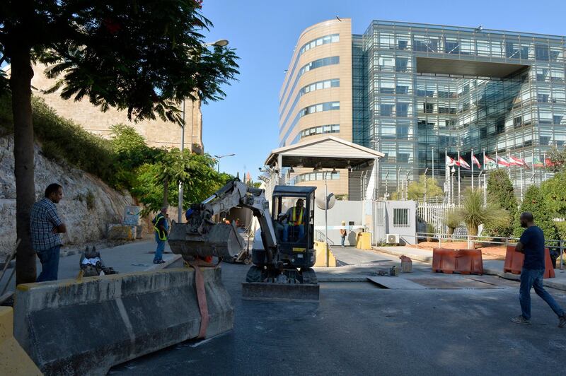 A bobcat works to remove the cement barrier to re-open a part of the street in front of the United Nations Building (ESCWA) in downtown Beirut, Lebanon. Roads around a United Nations Building (ESCWA) in Beirut were closed on 11 October 2011 as part of measures to protect the building following a series of attacks on the United Nations.  EPA